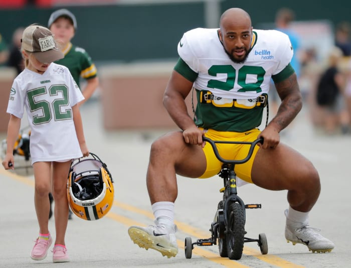 Running back AJ Dillon takes a slightly undersized bike to Packers training camp. (Dan Powers/USA Today Sports Images)